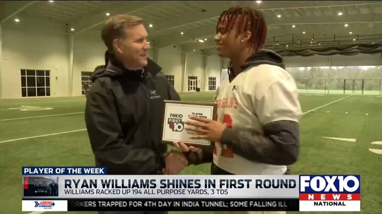 Personal Injury Attorney David Greene awarding Ryan Williams with Player of the Week