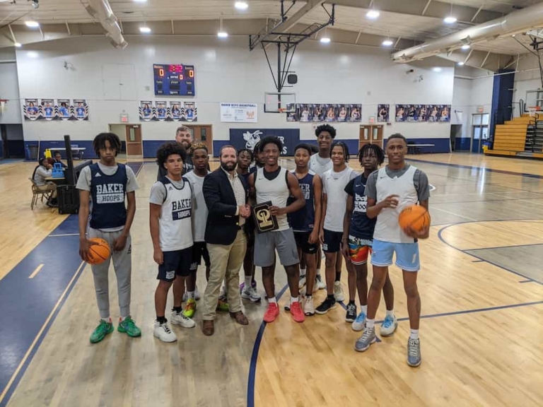 Attorney Chase Barber presents Dashawn Thomas the Player of the Week Award
