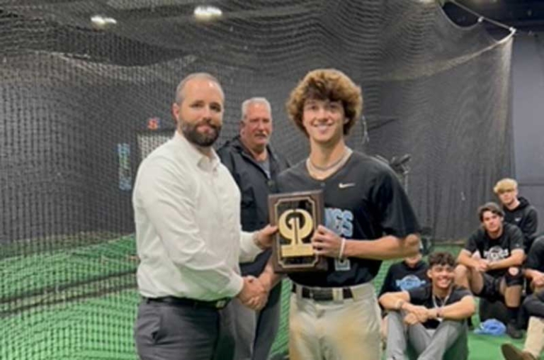 Chase Barber presenting Greene & Phillips Player of the Week award to Justin Friend